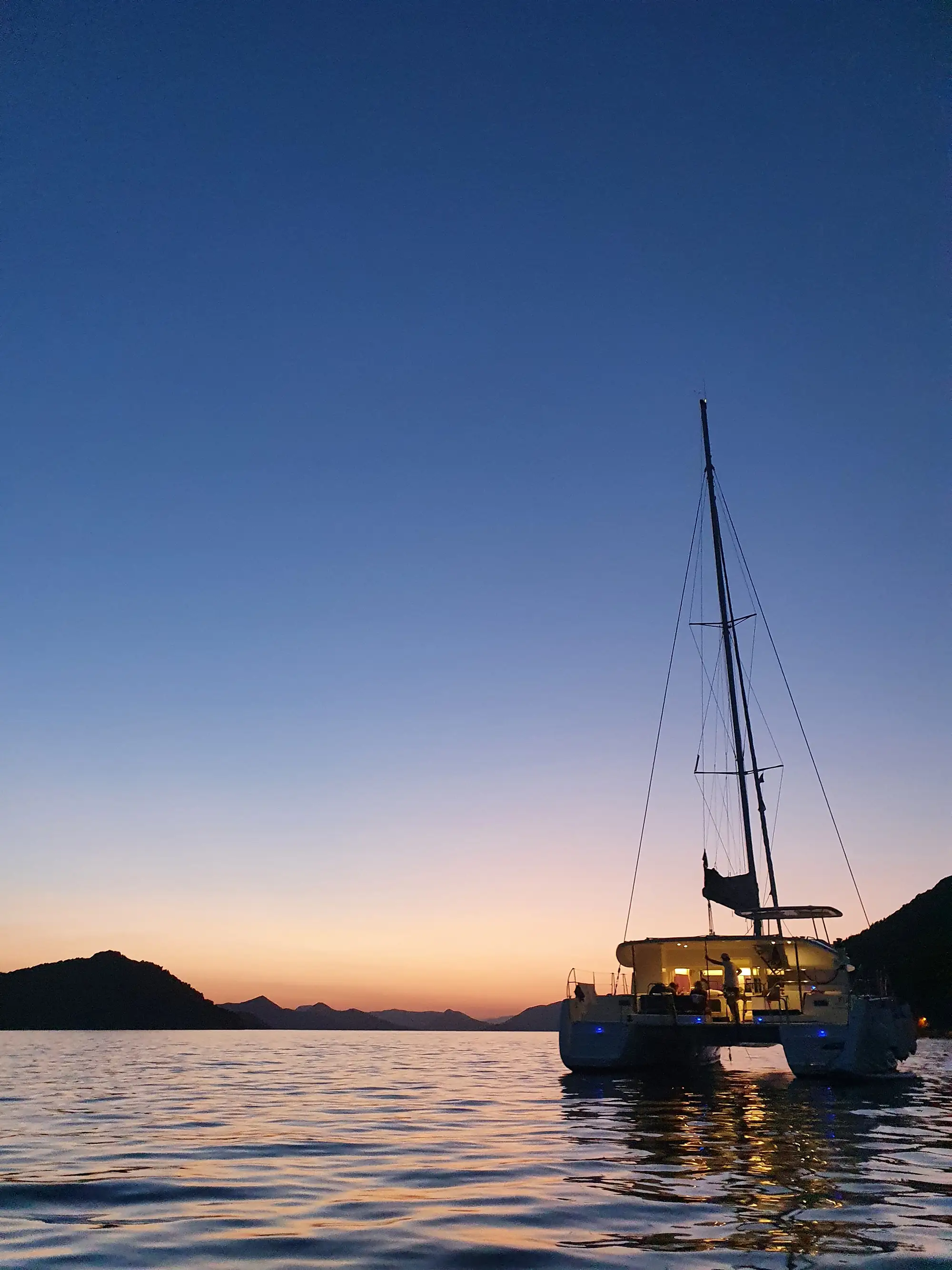 Catamaran lights on the sunset