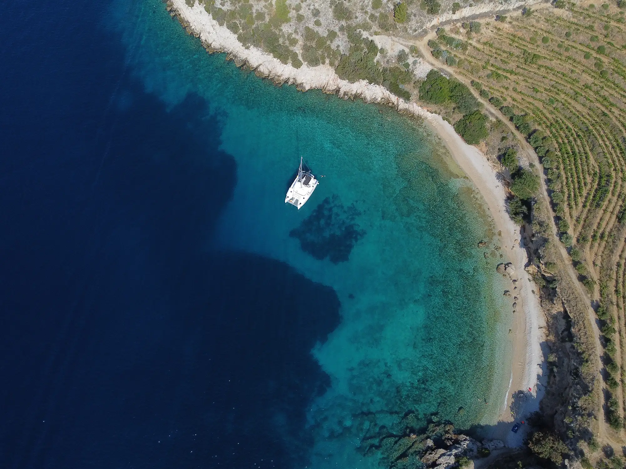 Catamaran top view near the island, perfect seclusion, route for couples