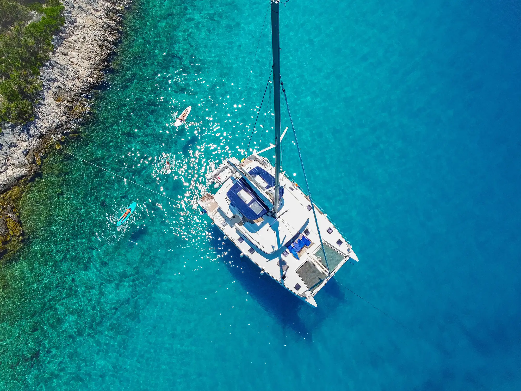 People swimming near the catamaran in the Adriatic Sea