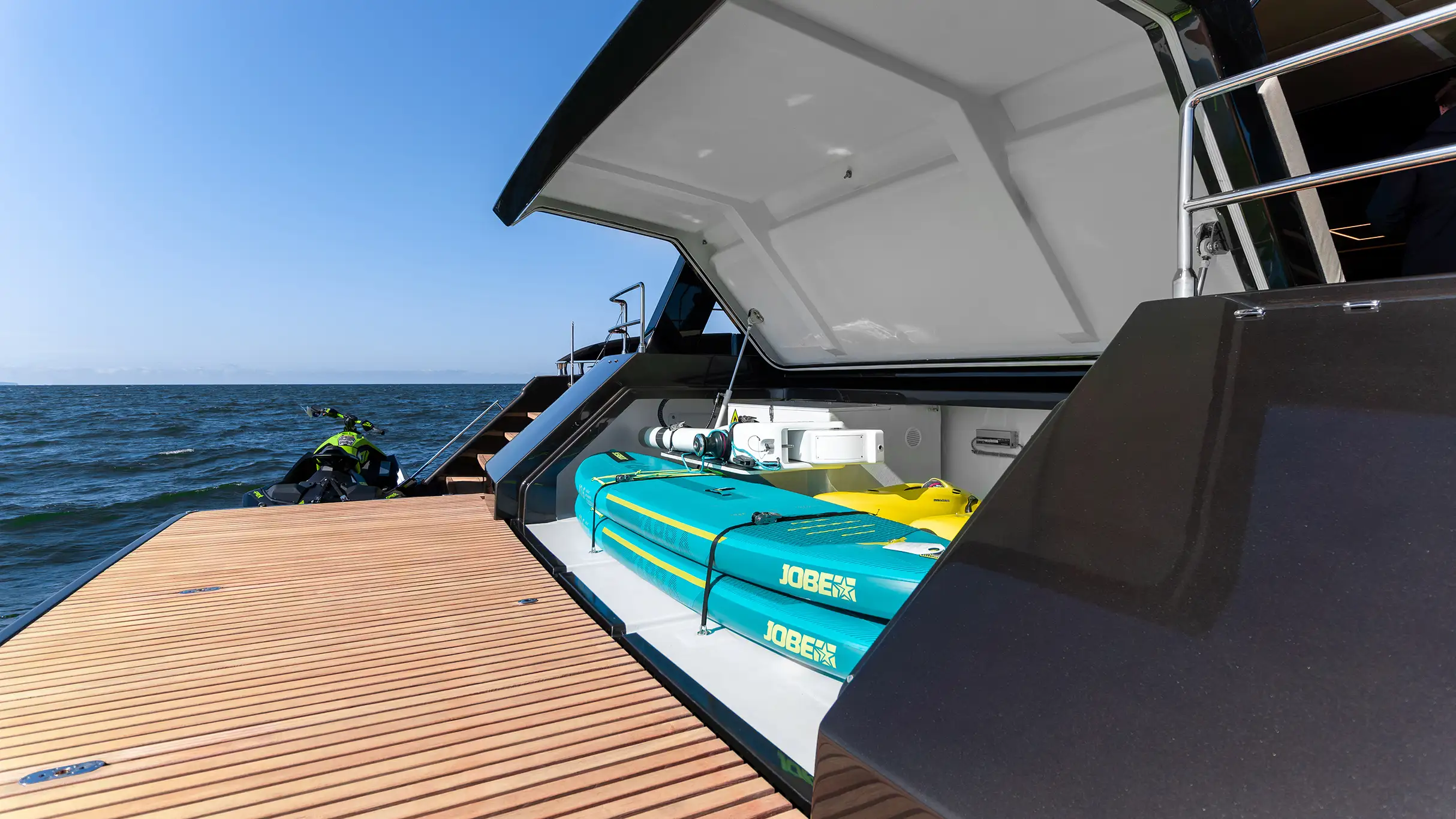 Stern of the yacht with jet ski and water board