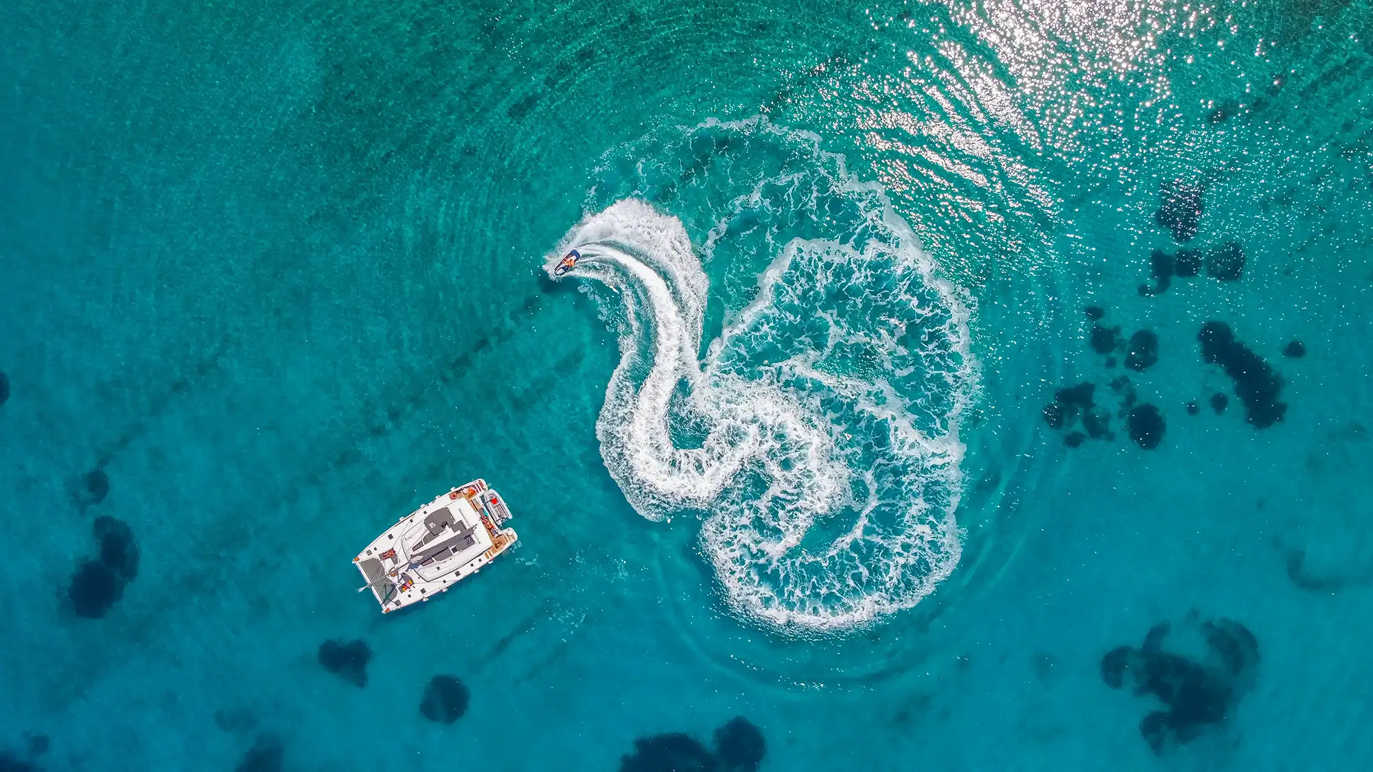 Bird view catamaran and jet ski